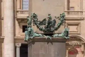 Obelisk St. Peter's Square – Coat of Arms Sixtus V with Lions and Eagle Bronze coat of arms at the base of the St. Peter's Square obelisk with two lions, three mountains and a crowned eagle – symbols of Popes Sixtus V and Innocent XIII.